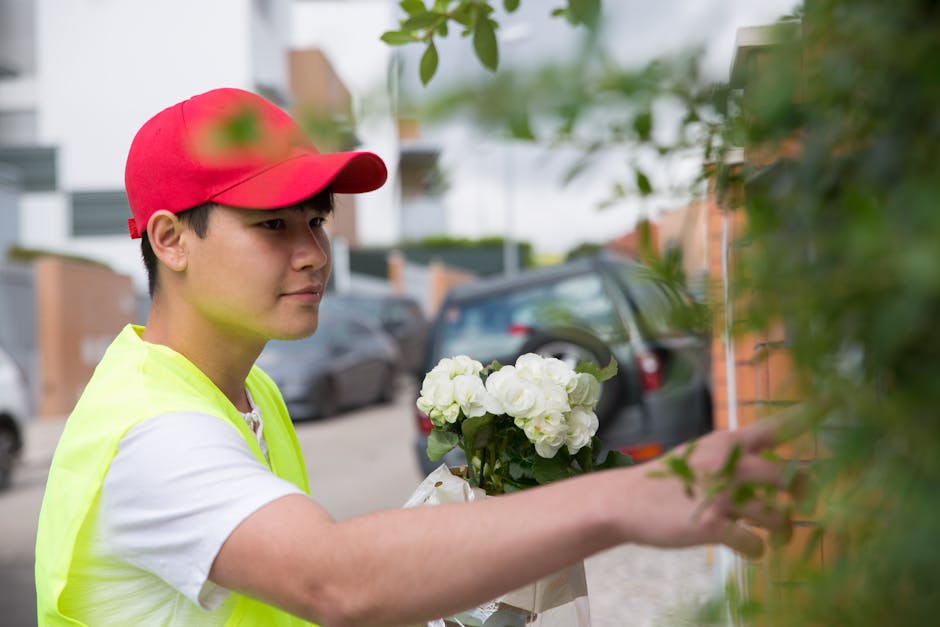 Person delivering a beautiful flower arrangement to a customer's door, emphasizing reliable flower delivery service