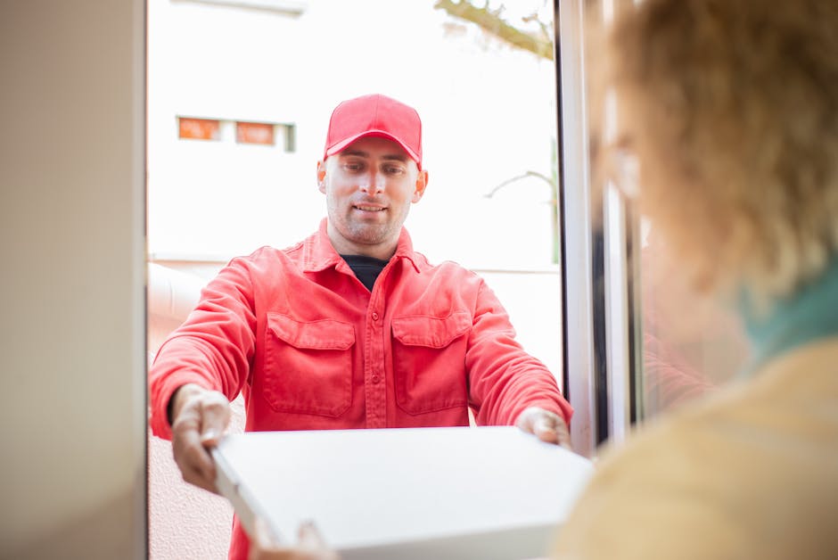 Professional delivery driver handing over a beautifully wrapped flower bouquet