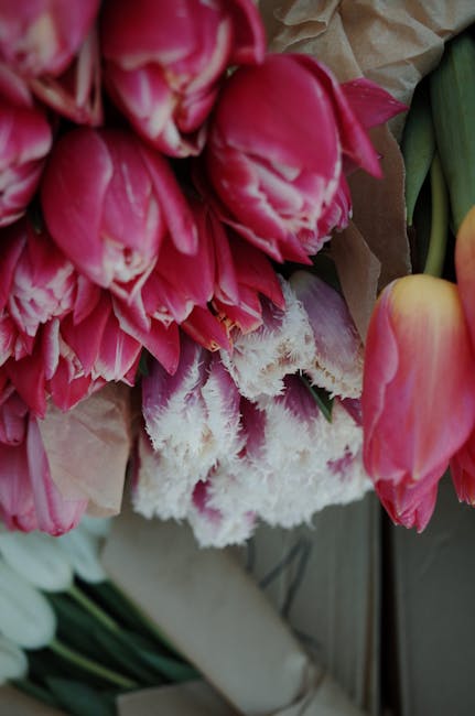 Skilled florist carefully selecting fresh cut flowers for a custom bouquet